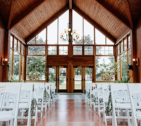 Inside a large conservatory building with chairs