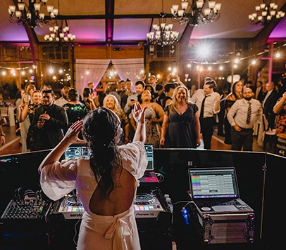 A female DJ playing music for a reception